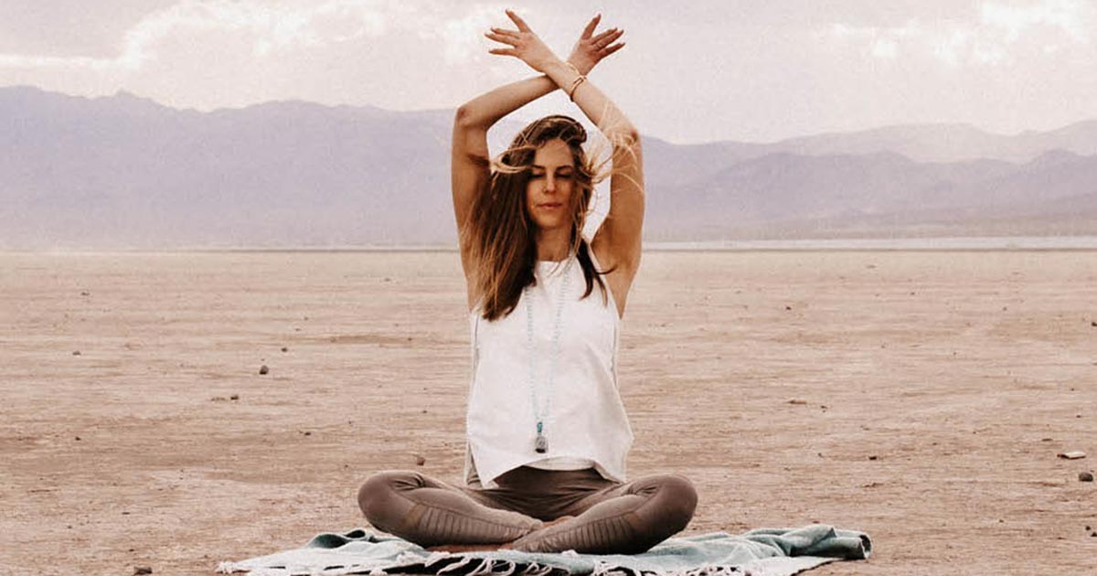 Author Rachel Spillane practicing yoga in the desert